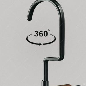 May include: Black metal hanger with a curved top and a 360-degree rotation symbol. The hanger has a sleek, modern design, suitable for organizing clothing. The image is set against a neutral background.