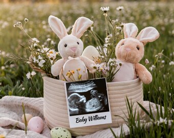 May include: A wicker basket filled with spring flowers and two plush bunny rabbits. A framed ultrasound image with the text "Baby Williams" is in front of the basket.