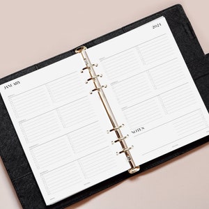 May include: A black planner with a gold ring binder. The planner is open to January 2024 and has a weekly layout with space for notes.