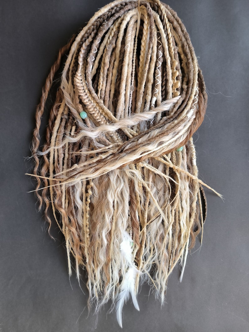 May include: A set of long, brown, blonde, and white synthetic dreadlocks with beads and feathers.