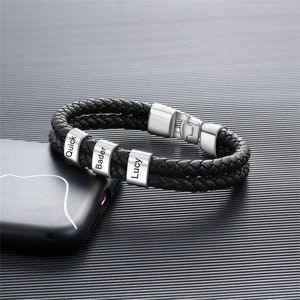 May include: Black leather bracelet with silver metal beads engraved with the names "Quick", "Bader", and "Lucy".