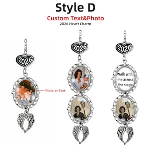 May include: A silver-toned hanging ornament featuring a heart charm with the text 2026, oval frames containing custom photos or text, and a pair of angel wings at the bottom. The text Style D Custom Text&Photo 2026 Heart Charm is visible.