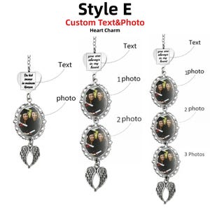 May include: A silver-toned metal hanging ornament featuring a heart-shaped charm with custom text, one to three oval photo frames with ornate filigree borders, and a pair of angel wings at the bottom. The text reads you are always in my heart.