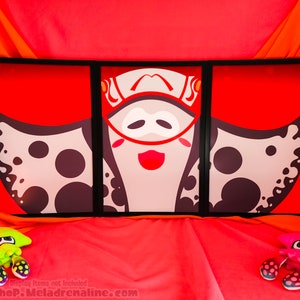 May include: A three-panel framed print featuring a cartoon character with a large, white, spotted, manta ray-like head and a red mouth. The character is wearing a white helmet with a red stripe and a black mask. The background is red.