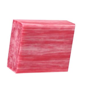 May include: A rectangular block of pink and white marbled soap. The soap has a smooth, polished surface with a layered, swirled pattern. The color is a vibrant pink with white streaks throughout.