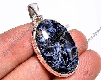 May include: Silver pendant featuring a blue and gold tiger's eye gemstone. The oval-shaped gemstone is set in a silver bezel and has a smooth, polished finish.
