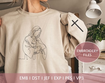 May include: A beige sweatshirt with a line drawing of Jesus holding a lamb. The sweatshirt has a black cross embroidered on the sleeve. The text "EMB | DST | JEF | EXP | PES | VP3" and "EMBROIDERY FILES" are printed on the sweatshirt.