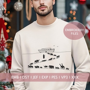 May include: Cream-colored sweatshirt with a black line drawing of Noah's Ark, animals, and a person. The text "EMBROIDERY FILES" is in a pink circle. Below the design are the letters "EMB I DST I JEF I EXP I PES I VP3 I XXX".