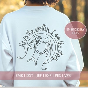May include: White sweatshirt with black embroidery of hands shaping clay with the text "He is the potter, I am the clay".