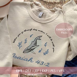 May include: Cream-colored sweatshirt with an embroidered whale design and the text "When you go through deep waters. I will be with you. Isaiah 43:2." The design includes blue accents and floral elements. The sweatshirt is a crew neck.