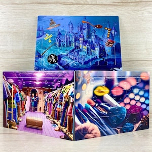 May include: Three different jigsaw puzzles, each with a different image. The first puzzle shows a colorful illustration of a castle with a wizard's hat and a wand. The second puzzle shows a colorful illustration of a room with a closet full of clothes. The third puzzle shows a colorful illustration of makeup brushes and a makeup palette.