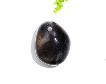 May include: A dark purple and black gemstone pendant with a hole drilled through the top for stringing.
