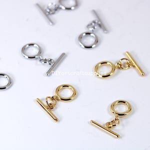 May include: Gold and silver toggle clasps with a round ring and a bar. These clasps are perfect for jewelry making, purse straps, and other DIY projects.
