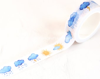 May include: A roll of decorative washi tape featuring a weather pattern design. The tape has a white background with blue clouds, rain, lightning, and yellow sun illustrations. The tape is ideal for scrapbooking and craft projects.