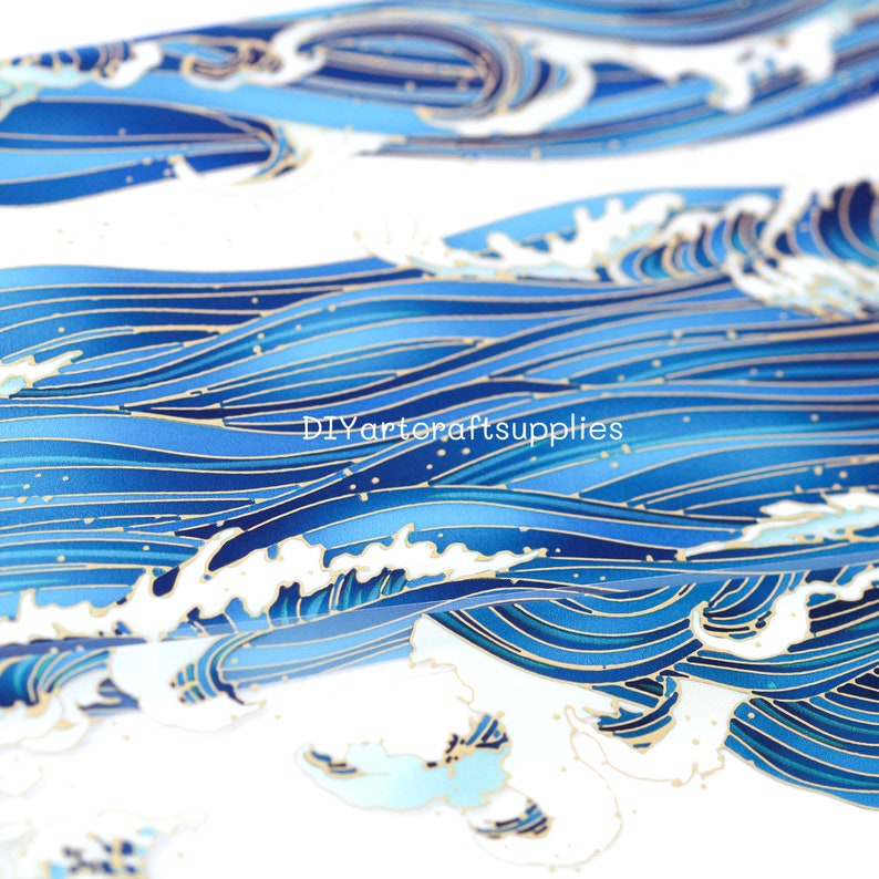 May include: Blue and gold patterned fabric with a wave design. The fabric has a subtle shimmer and is perfect for crafting projects.