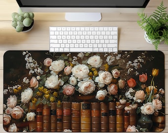 May include: A black and white vintage painting of a bouquet of white and pink roses, tulips, and other flowers in a vase. The flowers are arranged in front of a stack of old books with gold lettering on the spines.