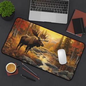 May include: A brown moose stands in a forest clearing with a stream running through it. The scene is painted in warm, autumnal colors with a golden sunset in the background.