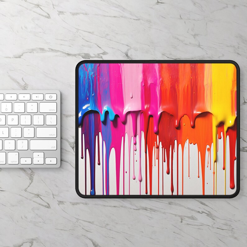 May include: A colorful abstract mouse pad with dripping paint in shades of blue, pink, orange, yellow, and red. The paint drips down a white background.