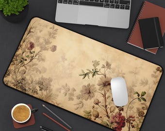 May include: A vintage-style floral mousepad with a beige background and a variety of flowers in shades of pink, red, and green. The mousepad has a black border.
