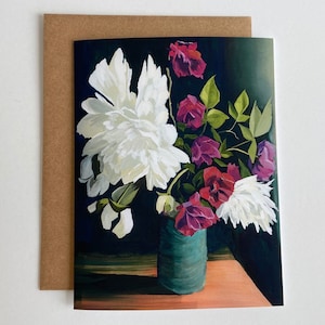 May include: A bouquet of white and pink flowers in a teal vase against a dark green background. The flowers are arranged in a loose, natural style, and the vase is simple and elegant.