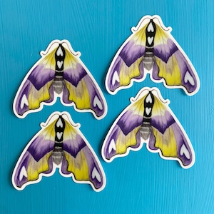 May include: Four purple and yellow moth stickers with white hearts on a blue background.