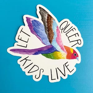 May include: A sticker with a colorful bird flying with the words "Let Queer Kids Live" around it.