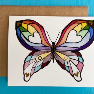 May include: A colorful butterfly with rainbow wings and gold hearts. The butterfly is drawn in a stained glass style.