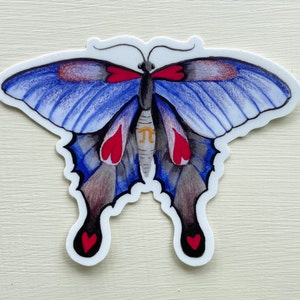 May include: A blue and gray butterfly sticker with red hearts and a gold pi symbol on its wings.