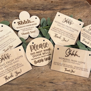 May include: A set of six wooden signs with the text "Shhh... Working from home and excited dog!" and "Please do not ring door bell! Working from home. Thank you!" The signs are laser engraved and have holes for hanging.