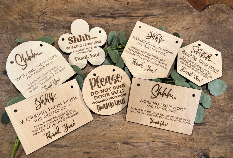 May include: A set of six wooden signs with the text "Shhh... Working from home and excited dog!" and "Please do not ring door bell! Working from home. Thank you!" The signs are laser engraved and have holes for hanging.