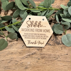 May include: A wooden sign with the text "Shhh... Working from home. Please do not ring the door bell. Friends and family please call or text. Packages can be left at the door. Thank you!"