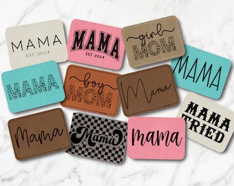 May include: A collection of nine leather patches with various designs and text, including "Mama", "Girl Mom", "Boy Mom", and "Mama Tried". Some patches feature a leopard print pattern.