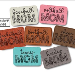 May include: A white ceramic mug with a black handle and the text "But First, Coffee" in a bold, black font. The mug is set against a blurred background, suggesting a cozy setting.