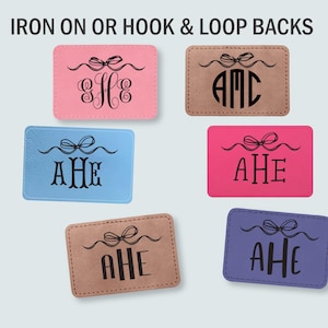 May include: Six rectangular patches in pink, tan, light blue, hot pink, brown, and purple. Each patch features a black printed graphic of a bow above a three-letter monogram. The text IRON ON OR HOOK & LOOP BACKS is displayed at the top of the image.