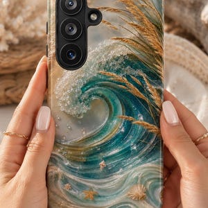 May include: A rectangular smartphone case featuring a printed design of a crashing ocean wave in shades of teal, blue, and white, accented with golden wheat stalks, small seashells, and starfish. The case has a black camera module cutout.