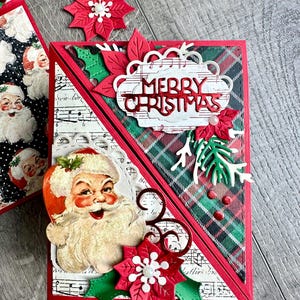 May include: A handmade Christmas greeting card featuring a vintage Santa Claus illustration, a red die-cut Merry Christmas sentiment, and layered paper poinsettias. The card design incorporates green and red plaid patterns, musical sheet music motifs, and small white pearl accents.