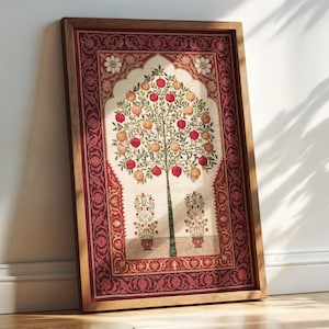 May include: A rectangular framed wall art piece featuring a central tree laden with red and yellow pomegranates, set within an arched cream-colored panel. The border is a deep red with intricate floral patterns, all encased in a light wood frame.