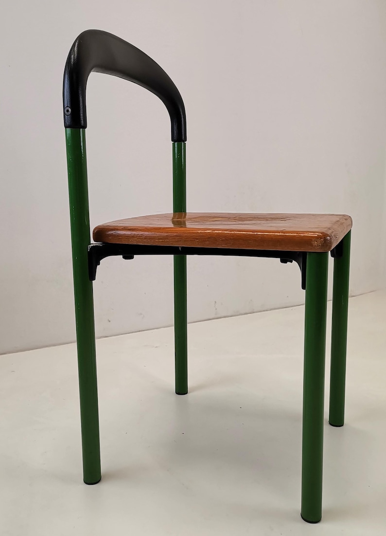 May include: A green metal chair with a black curved back and a wooden seat.