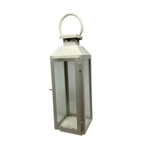 May include: A tall, off-white metal lantern with a rectangular frame and clear glass panels on all sides. It features a hinged door with a small latch on the side and a circular handle attached to the top for carrying or hanging purposes.