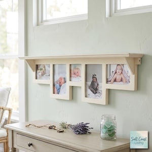May include: A cream-colored wall-mounted shelf featuring five integrated rectangular photo frames of varying heights. The shelf displays five black and white photographs of infants and young children. The structure is made of wood with a smooth finish.