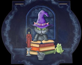 May include: A black cat wearing a purple and orange witch hat sits reading a book by candlelight. The cat is surrounded by potion ingredients, including a mortar and pestle, a frog, and a stack of books. The text around the image reads: "2 drops of dragon blood", "Eye of newt, 2 bat wings", "Bone dust, Fly Agaric", and "Snake venom, toe of frog".