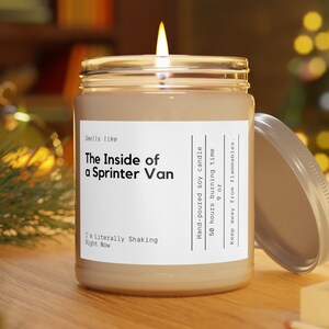 May include: A beige soy candle in a glass jar with a white label that reads "Smells like The Inside of a Sprinter Van I'm Literally Shaking Right Now". The label also includes the text "Hand-poured soy candle 50 hours burning time 9 oz Keep away from flammables."
