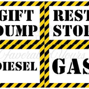 May include: A square sign with four sections, each with a black stencil font on a white background. The words "GIFT DUMP", "REST STOP", "DIESEL", and "GAS" are displayed. The sign has a yellow and black striped border.