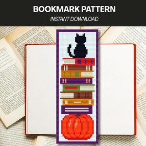 May include: A cross-stitch bookmark pattern featuring a black cat sitting atop a vertical stack of colorful books, which rests on a large orange pumpkin. The design includes the text BOOKMARK PATTERN and INSTANT DOWNLOAD at the top.