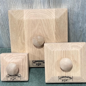 May include: Three wooden square boxes with rounded edges and a knob on top. Each box has a label that reads "Handcrafted by Eyell".