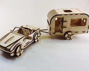 Puede incluir: Un modelo de madera de un coche descapotable tirando de una caravana de madera. Ambos están hechos de madera marrón claro y tienen detalles elaborados.