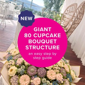 May include: A giant 80 cupcake bouquet structure featuring an arrangement of floral-piped cupcakes in shades of cream, soft pink, lavender, and blue, wrapped in white paper with gold trim, accompanied by a guide titled NEW GIANT 80 CUPCAKE BOUQUET STRUCTURE.