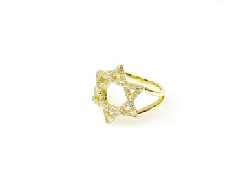 May include: A gold ring with a clear crystal star of David design.
