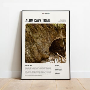 May include: A poster with a black frame and a white background. The poster features a photo of a stone archway with a trail leading through it. The text "Alum Cave Trail" is in large, bold letters at the top of the poster. The text "Tennessee & North Carolina" is in smaller letters below the title. The poster also includes information about the trail, such as the distance, highest point, and duration.