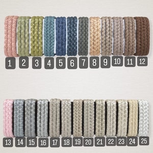 May include: A collection of 25 different colors of braided cord, arranged in two rows. The cords are all the same thickness and have a subtle sheen. The cords are numbered 1 through 25.